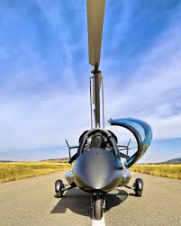 Gyroplane head-on on the runway, rotor blade across frame